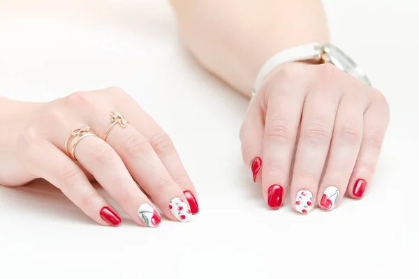 Female hands with manicure, red nail polish, drawing with cherries