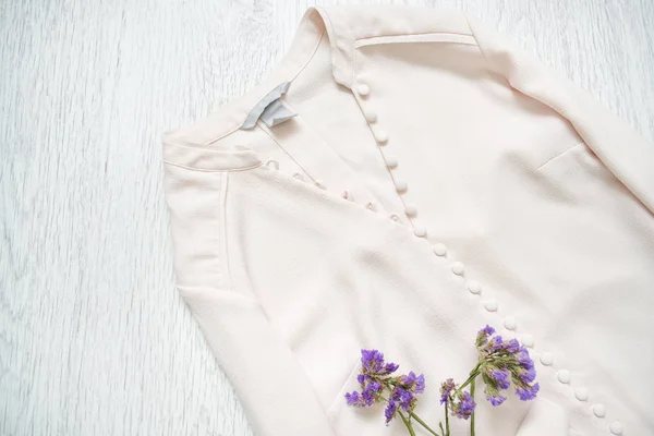 Pink blouse with buttons and wildflowers. Fashionable concept — Stock Photo, Image
