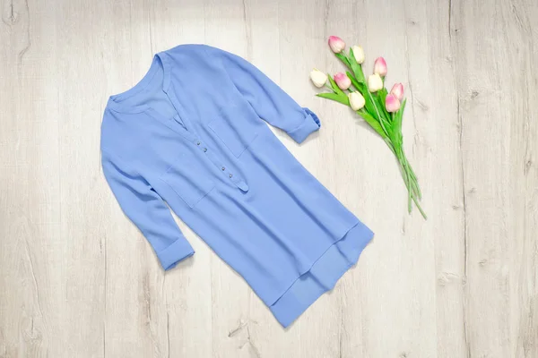 Blue blouse, bouquet of tulips. Fashionable concept