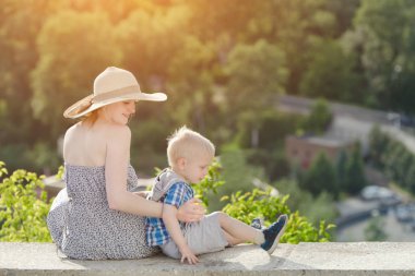 Anne ve oğlunun bir tepe üzerinde oturuyor.