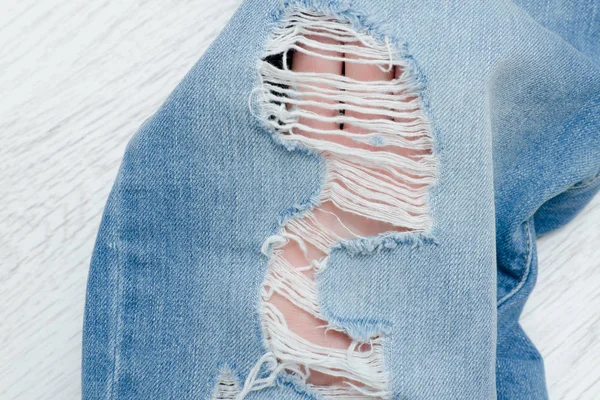 Part of blue ripped jeans. Details close-up — Stock Photo, Image