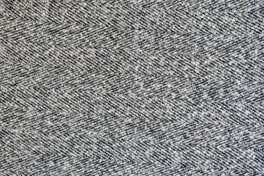 Ringa kemiği desenli beyaz ve gri yün doku. Sağlam ve kesintisiz arka plan.