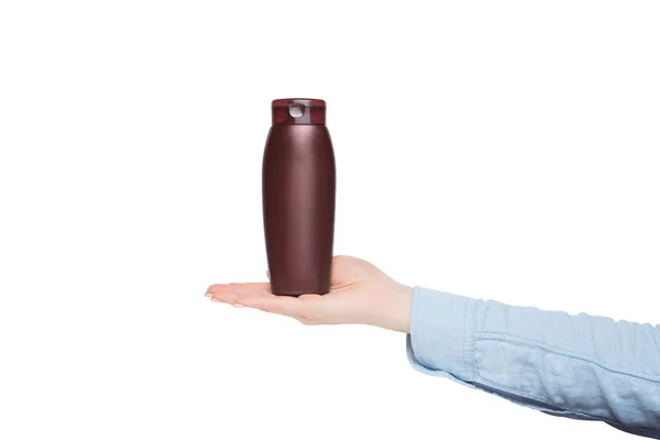 Brown bottle for cosmetic in a female hand. Mockup. Isolate — Stock Photo, Image