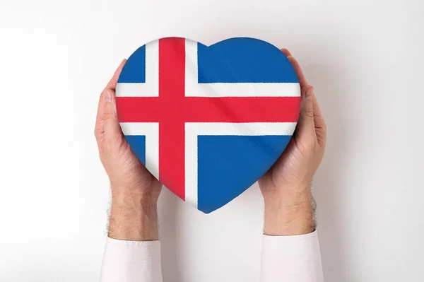 Flag of Iceland on a heart shaped box in a male hands. White background — Stock Photo, Image