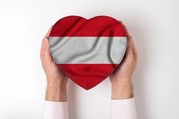 Flag of Austria on a heart shaped box in a male hands. White background — 스톡 사진