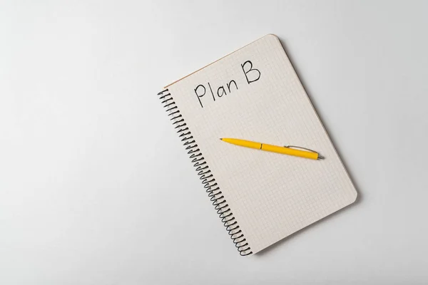 Plan B text in copybook. Notepad and pen on white background top view. — Stock Photo, Image