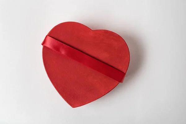 Red heart shaped box with ribbon on the white background. Top view. Gift for Valentine's day — Stock Photo, Image