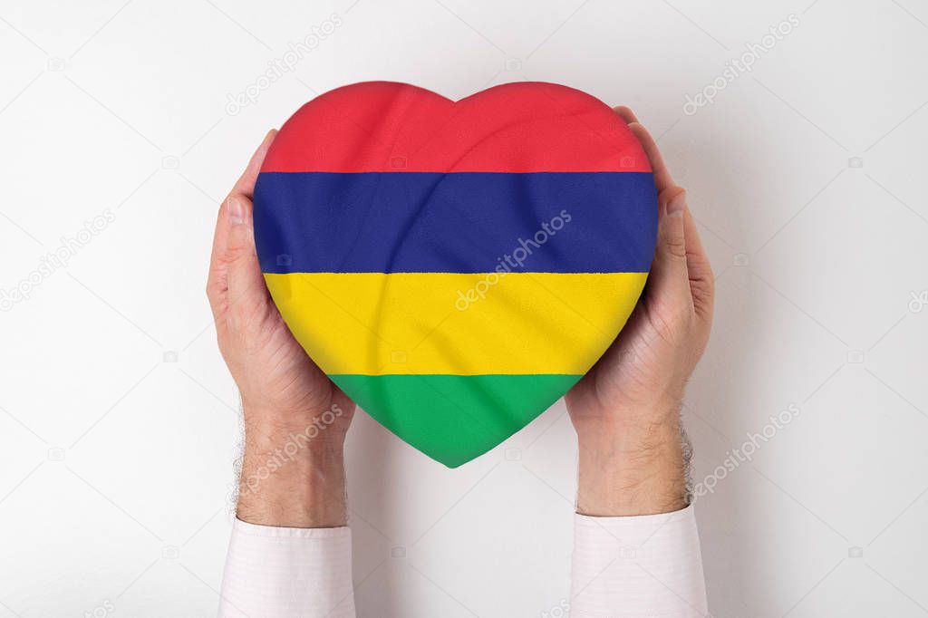 Flag of Mauritius on a heart shaped box in a male hands. White background