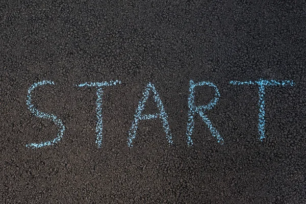 Inscription on the asphalt START chalk written. Chalk drawing on surface of road. — 스톡 사진