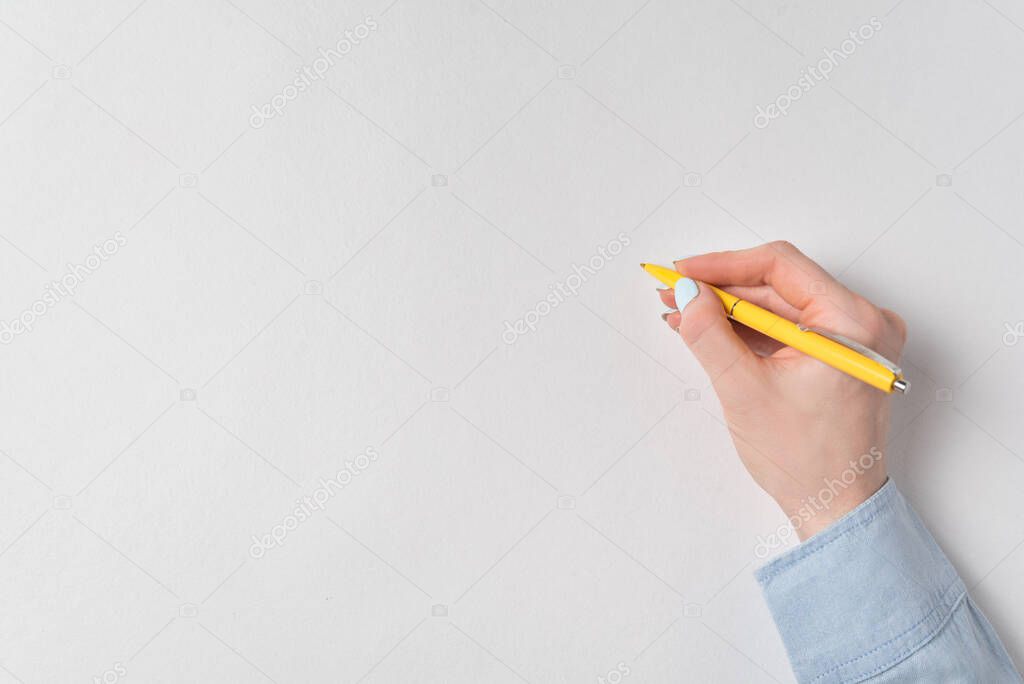 Female hand with pen on white background. Copy space