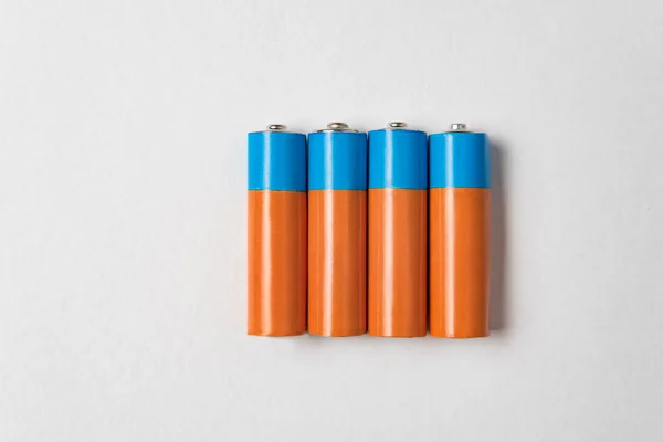 Cuatro pilas alcalinas AA sobre fondo blanco. Batería principal para fuentes de alimentación personales . —  Fotos de Stock