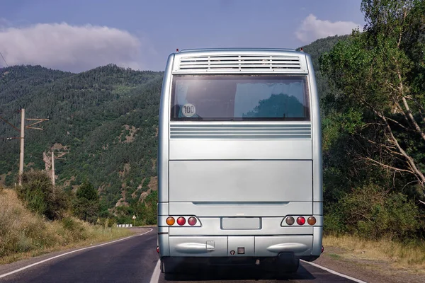 Rear side of bus. Behind white bus on nature background. Place for text. Close up