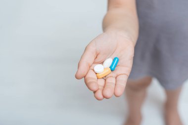 Avuç içi renkli haplarla dolu bir el. Vitaminler ve antibiyotikler. İlaç konsepti.