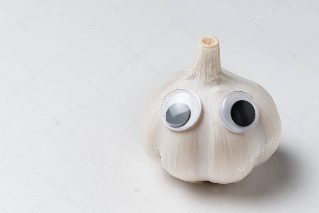 Garlic character with Googly eyes on white background. Garlic with funny face.