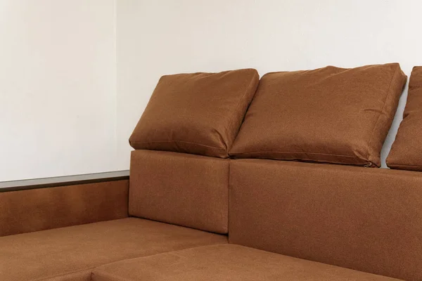 big corner sofa with fabric upholstery in brown colour