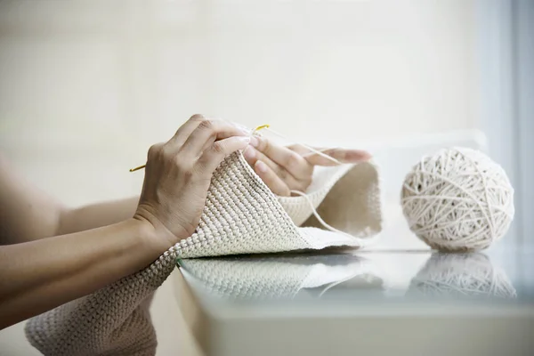 Woman\'s hands doing home knitting work - people with DIY work at home concept