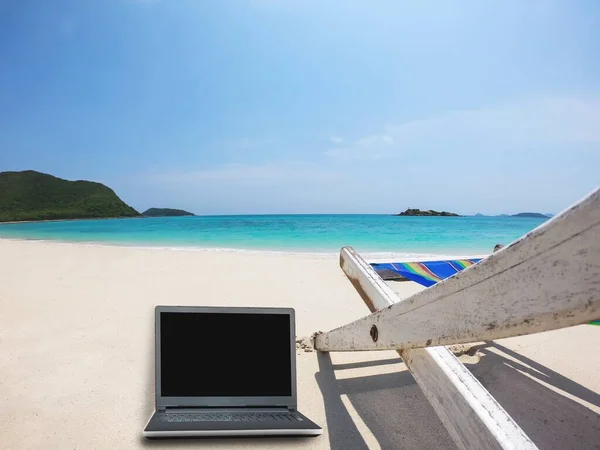 Relax beach chair with laptop on clean sand beach with blue sea and clear sky - sea nature background relax working holiday concept