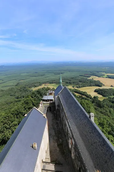 Telhados longos do castelo grande na colina entre florestas — Fotografia de Stock