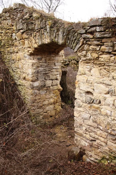 Old ruined wall with door passage