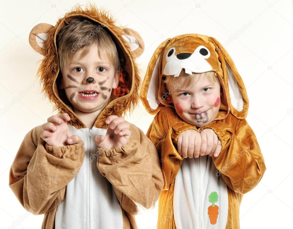 Pair of boys in costumes of lion and bunny