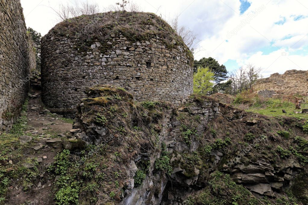 Ruins of rounded stony tower on the rock