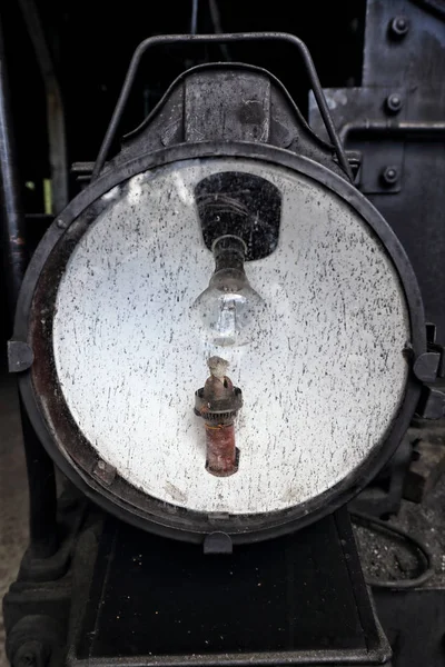 Historic railway engine light with bulb and spare kerosene lamp  behind glass cover