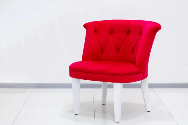 red armchair in white room