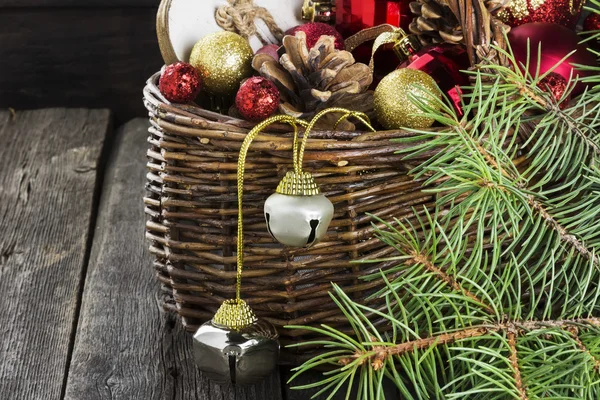 Christmas jewelry in a basket on a wooden background