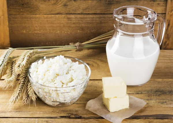 Organic products: milk, cottage cheese, butter, wheat on a woode