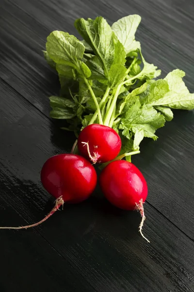 Fresh radish on a dark wooden background. — Stock Photo, Image