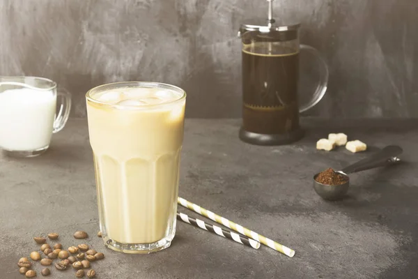 Stock image Ice coffee with milk in a tall glass on a dark background. Copy space. Food background. Toning