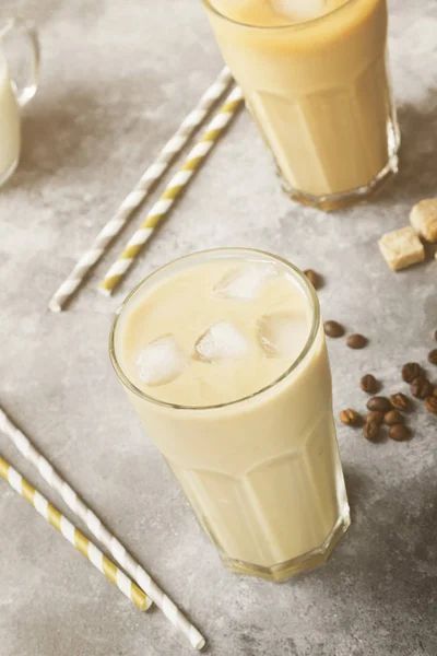 Φραπέ με γάλα, σε ένα ψηλό ποτήρι σε γκρι φόντο. Τόνωση — Φωτογραφία Αρχείου