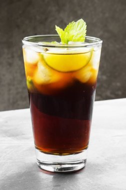 Bir bardak koyu arka plan üzerinde kokteyl Cuba Libre