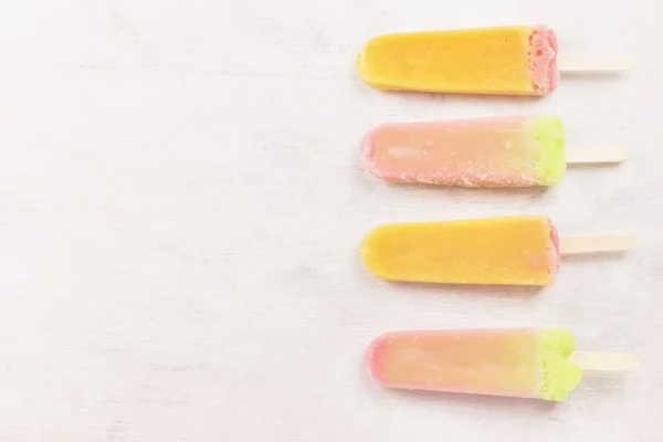 Multi-colored popsicles on a white background. Top view, copy sp — Stock Photo, Image