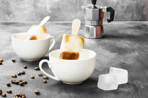 Koffie ijs ijslollys in witte koppen op een donkere achtergrond — Stockfoto