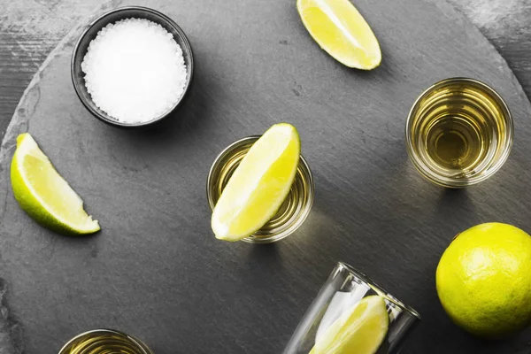 Tequila med lime och salt på en mörk bakgrund. Ovanifrån. Mat — Stockfoto