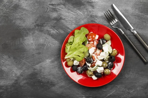 Greek salad feta, cherry tomatoes, olives, cucumbers on a dark b — Stock Photo, Image