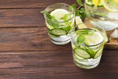 İçki salatalık, limon ve nane bir tahta üzerinde bardaklarda Detoks