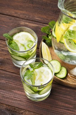 İçki salatalık, limon ve nane bir tahta üzerinde bardaklarda Detoks