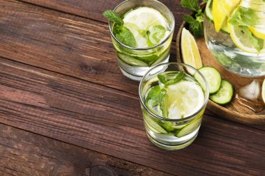 İçki salatalık, limon ve nane bir tahta üzerinde bardaklarda Detoks