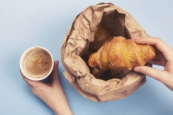 Breakfast to go - croissants and coffee with milk on blue background. Top view
