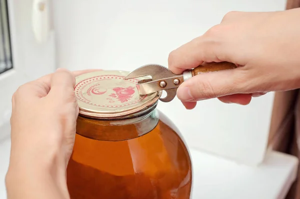 Open a jar of compote with a can opener