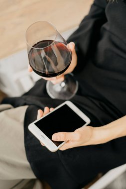 Telefon elinde tutarak şarap kadınla