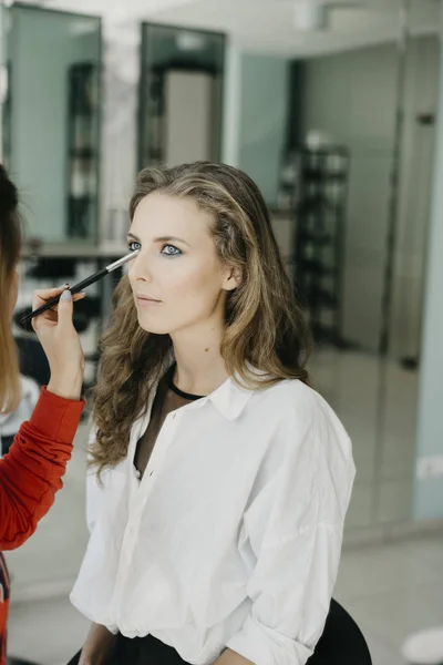 Chica joven haciendo maquillaje en un salón —  Fotos de Stock