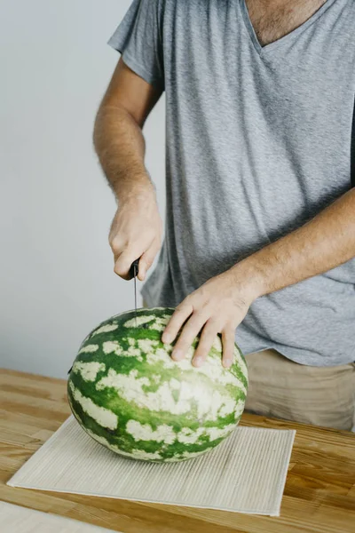 Genç adam bir karpuz keser