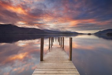 Flooded jetty in Derwent Water, Lake District, England at sunset clipart