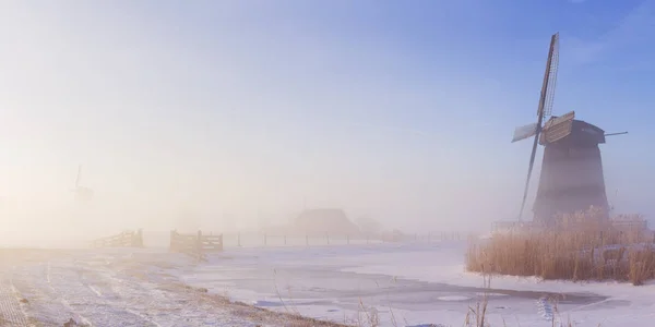 Dutch windmill in a foggy winter landscape in the morning — Stock Photo, Image