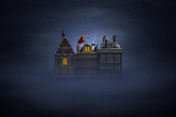 Sinterklaas und die Pieten auf den Dächern bei Nacht — Stockfoto