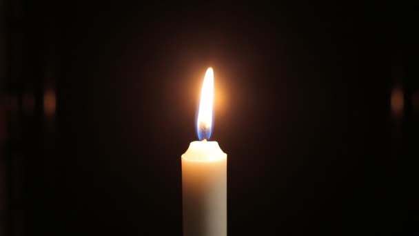 Closeup of candle on black background — Stock Video