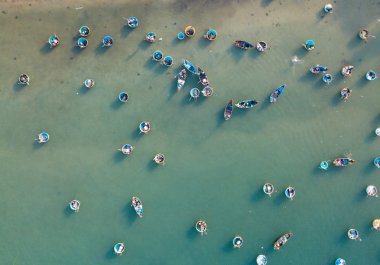 Top view, aerial view fishing harbour market from a drone. Royalty high-quality free stock image of the market at Mui Ne fishing harbour or fishing village. Fishing harbor is a popular tourist destination clipart